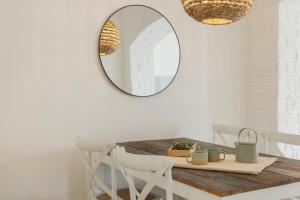 a dining room with a table and a mirror at Piperi-2 Bedroom home in Naousa