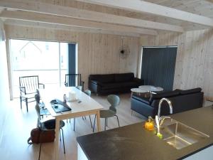 a kitchen and living room with a table and a couch at Captains Cottage in Sandur +20 photos