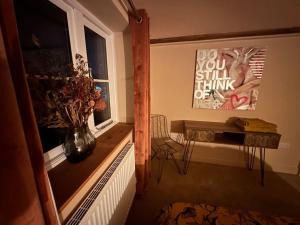 a room with a vase of flowers in a window at Luxury 2 bed cottage in the centre of Melbourne in Melbourne