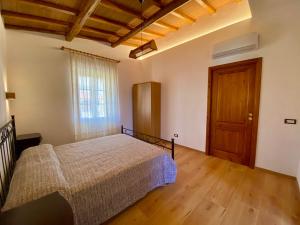 a bedroom with a bed and a wooden floor at Podere Il Ritorno in Portoferraio