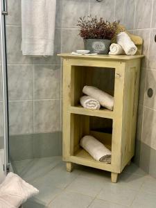 a wooden shelf in a bathroom with towels at Apartments Gabri in Mali Lošinj