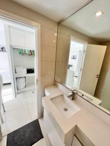 a white bathroom with a sink and a mirror at COOL VIEW Studio in CCR Condo in Pattaya Central