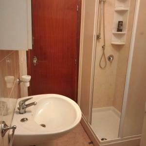 a bathroom with a sink and a shower at SENZATESTA 2 in Osimo