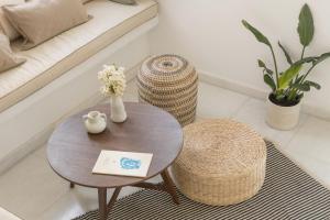 a living room with a table and a couch at Piperi-2 Bedroom home in Naousa