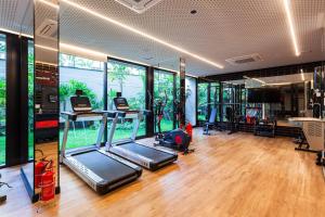 a gym with two treadmill machines in a room with windows at Tabas - Pivô Match - Vila Nova Conceição in Sao Paulo