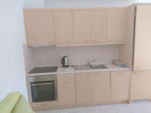a kitchen with white cabinets and a sink at One bedroom apartment with pool in Plakias