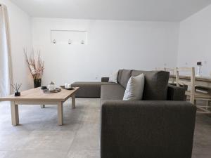 a living room with a couch and a coffee table at Cute apartments in Kefalos