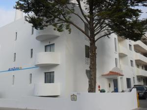 a white building with a tree in front of it at Alta Oura in Albufeira