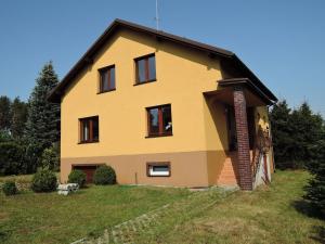 a yellow house with black windows on a hill at Holiday Home Kolczewo near Baltic Sea Beach in Kołczewo