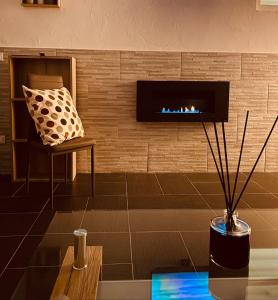 a living room with a fireplace and a chair at Dimora Falcone in Bari +15 photos