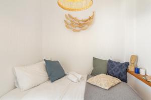 a room with a white couch with pillows at Piperi-2 Bedroom home in Naousa