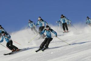 a group of people skiing down a snow covered slope at Hotel Aquila in Livigno