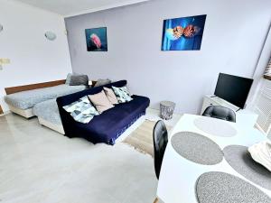 A bed or beds in a room at Studio Apartment with balcony 300m from beach Még 37 kép