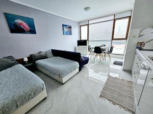 A seating area at Studio Apartment with balcony 300m from beach