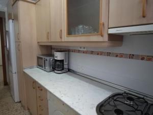 a kitchen with a counter top with a microwave at Casa Rural Dehesa de Algar in Algar