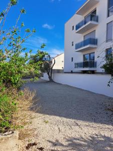 a building with a tree on the side of it at Apartment Jana in Korčula