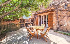 a patio with a table and chairs in front of a building at 2 Bedroom Cozy Home In Cbazan in Cébazan