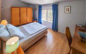 a bedroom with a bed and a table and a window at 2 Bedroom Cozy Home In Cbazan in Cébazan
