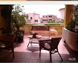 a patio with a table and two chairs and a table at Il Sole Baunei by the sea in Santa Maria Navarrese +48 photos