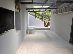 a hallway with a room with a staircase and a chair at Casa de campo en Panamá in Los Altos de Cerro Azul