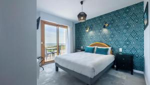 Postel nebo postele na pokoji v ubytování Hôtel l'Albatros
