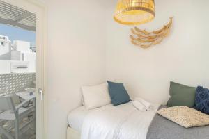 a bedroom with a bed and a chandelier at Piperi-2 Bedroom home in Naousa