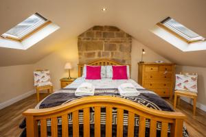 a bedroom with a large wooden bed with skylights at Birds Nest, Romantic getaway with stunning views in Matlock