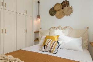 a bedroom with a white bed with pillows on it at Piperi-2 Bedroom home in Naousa