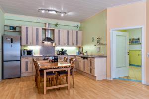 a kitchen with a table and chairs and a refrigerator at Ferienhaus Brigitte in Hornberg