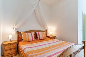 a bedroom with a canopy bed with two night stands at Ferienhaus Brigitte in Hornberg