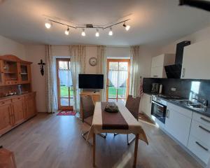 a kitchen with a table and a dining room at Ferienwohnung Beate Zierer in Eslarn