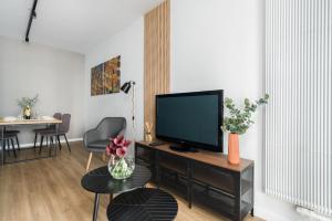 a living room with a flat screen tv on a table at Osiedle Goplana Apartment FREE GARAGE by Renters in Poznań