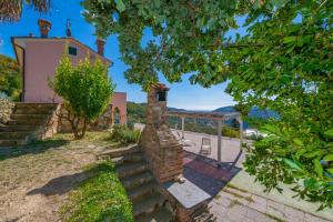 an external view of a house with a brick fireplace at Bike e Relax Villa in Bardino Vecchio