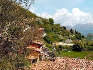 un groupe de maisons sur une colline avec des montagnes en arrière-plan dans l'établissement Hiking Escape Parzanica, à Parzanica