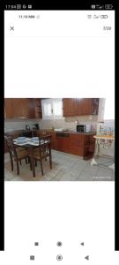 a kitchen with a table and chairs and a dining room at Porto-Heli Matilda's house in Porto Heli