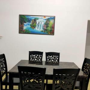 ポートディクソンにあるDistance 1km from beach and townのダイニングテーブル(椅子付)が備わります。壁には絵画が飾られています。