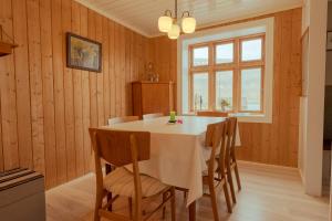 a dining room with a white table and chairs at Charming 3 bedroom house in a peaceful village in Hellur