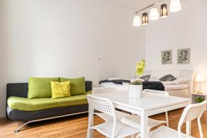 a living room with a couch and a table and chairs at Comfortable 2BR Apt Central and Well Connected in Vienna