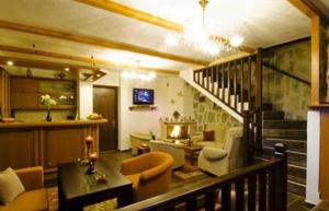 a living room with a staircase and a living room with a couch at Vigla Ias in Neos Marmaras