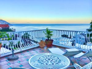 a patio with a table and chairs and the ocean at Hotel Villa Delle Palme in Positano in Positano