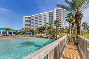 a view of a resort with a pool and palm trees at Palms of Destin 2710 in Destin
