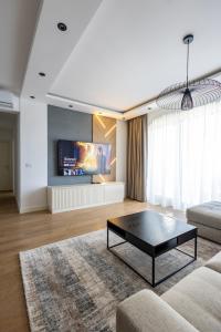 a living room with a couch and a coffee table at Terra Luxe Residences in Sajmište