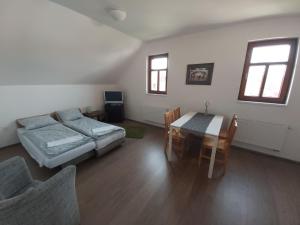 a living room with a couch and a table at Pivní lednice in Lhota pod Libčany