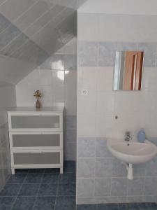 a bathroom with a sink and a mirror at Pivní lednice in Lhota pod Libčany