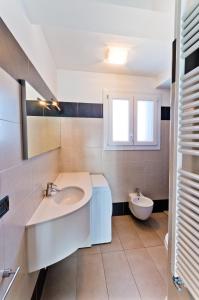 a bathroom with a sink and a toilet at Villa Marina Apartments - Agenzia Cocal in Caorle