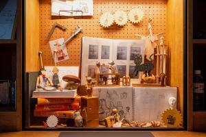 a display case with a bunch of toys and books at HOTEL ALGO in Kobe