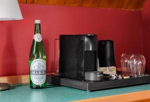 a bottle of beer sitting on a counter next to a microwave at Buitenplaats Iepenoord in Oostkapelle