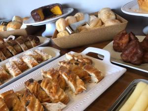 a table topped with different types of pastries and other foods at POUSADA MALA E CUIA in Rifaina