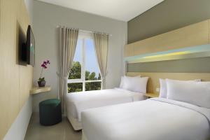 Säng eller sängar i ett rum på Zizz Convention Hotel