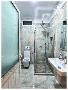 uma casa de banho com um chuveiro, um WC e um lavatório. em Vila HK em Krujë